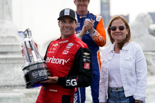 Will Power celebrates with the winning trophy with General Motors chair and chief executive officer Mary Barra after winning the IndyCar Detroit Grand Prix.