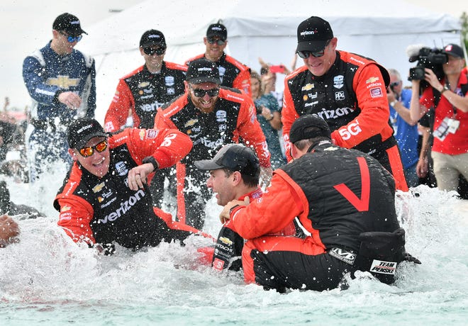 Winner Will Power, bottom center, celebrates with his team in the James Scott Memorial Fountain at the Detroit Grand Prix.