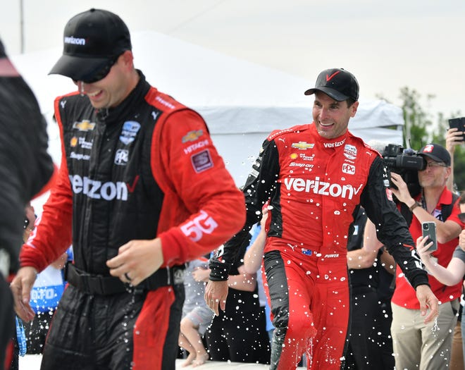 Winner Will Power, right, celebrates with his team in the James Scott Memorial Fountain at the Detroit Grand Prix.