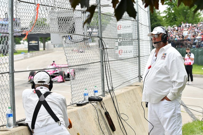 Race marshal Steven Ringler of Ontario, right, works in turn 1 at the Detroit Grand Prix.