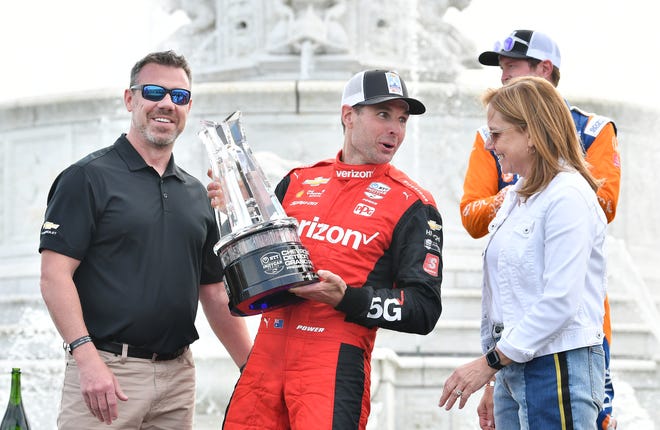 Winner Will Power with Scott Bell, vice president of Global Chevrolet, left, and General Motors CEO Mary Barra, right, at the Detroit Grand Prix.