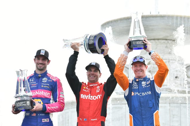 From left, Second place finisher Alexander Rossi, winner Will Power and third place finisher Scott Dixon with their trophies at the Detroit Grand Prix.