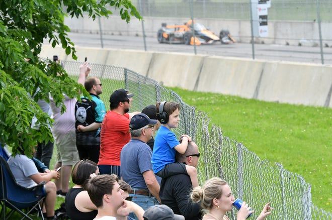 Ollie Gurtowski, 6, sits on the shoulders of his dad, Mike Gurtowski of Dexter near turn 3 at the Chevrolet Detroit Grand Prix on Belle Isle in Detroit on June 5, 2022.   
(Robin Buckson / The Detroit News)