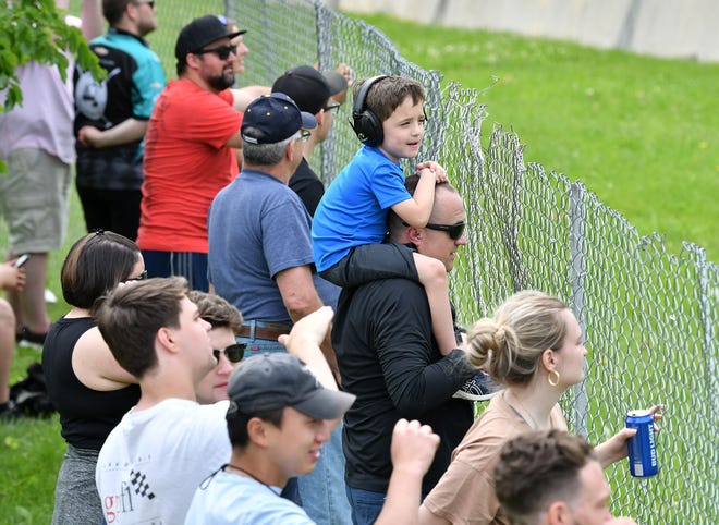 Ollie Gurtowski, 6, sits on the shoulders of his dad, Mike Gurtowski of Dexter near turn 3 at the Detroit Grand Prix.