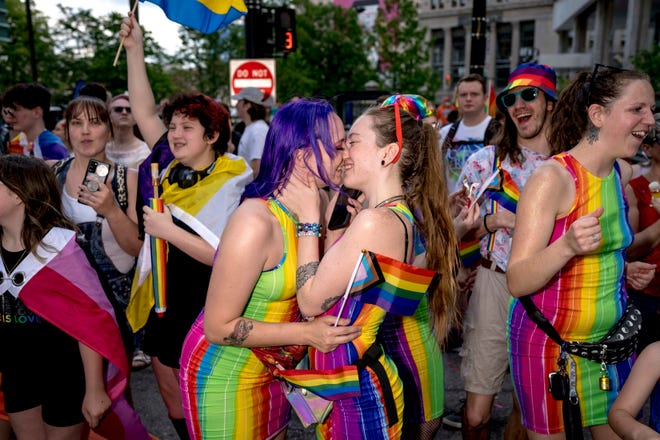 Ciara Hayes of Ferndale, left, kisses Alana Whitehead of Kalamazoo during the Motor City Pride parade in Detroit.
