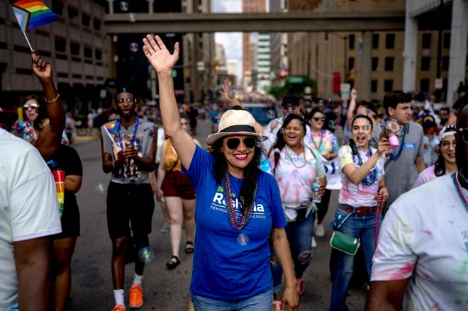 Rep. Rashida Tlaib waves during the Motor City Pride parade in Detroit.