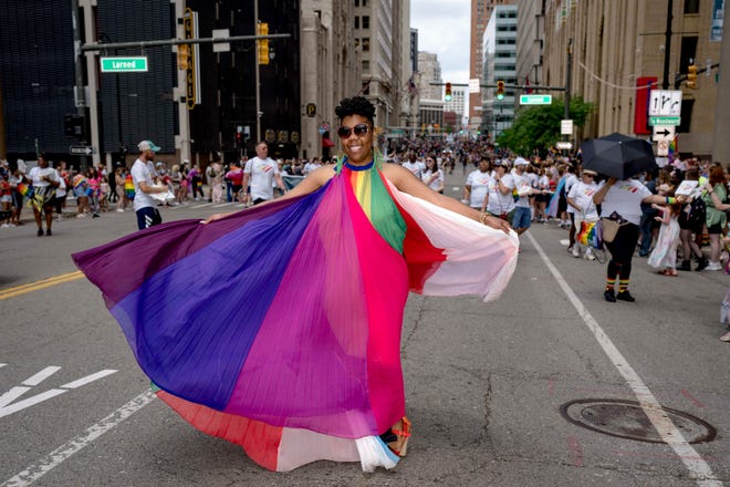 Latavia Mallet of Detroit twirls during the Motor City Pride parade in Detroit.