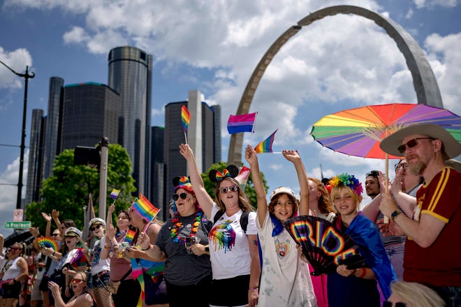People cheer during the Motor City Pride parade in Detroit on June 12, 2022.
