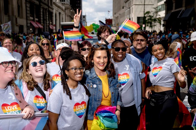 Gov. Gretchen Whitmer poses with supporters during the Motor City Pride parade in Detroit.