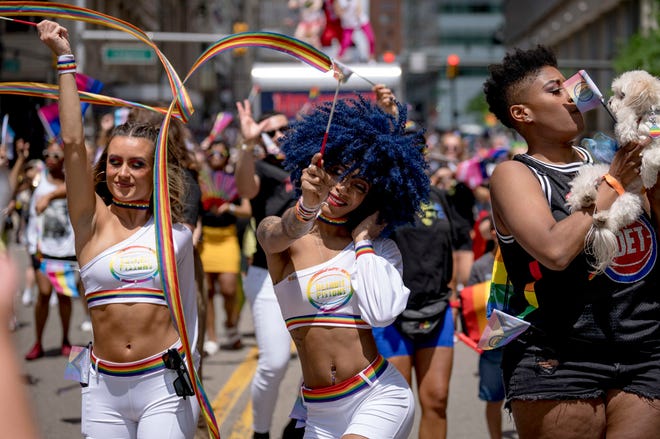 Detroit Pistons dancers, from left, Miranda Richards of Canton, Loko Bleu of Westland and Taylor Anderson of Ann Arbor dance during the Motor City Pride parade.
