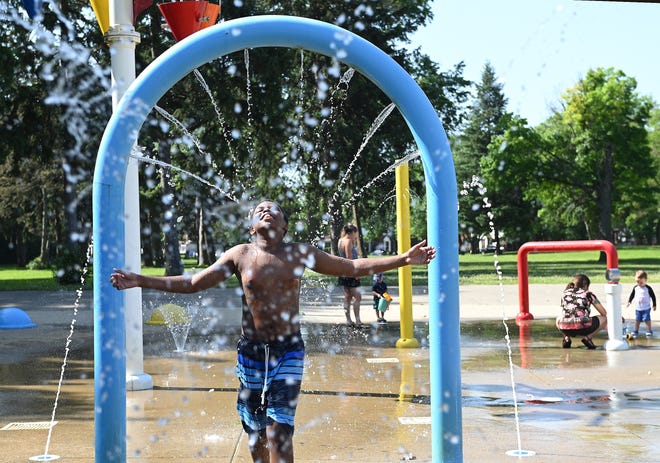 NaShawn Davis,11, of Detroit, enjoys the Palmer Park Splash Pad in Detroit.