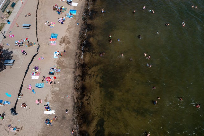 Dozens of people enjoy the warm weather while visiting Mercer Beach, in Walled Lake, June 15, 2022.
