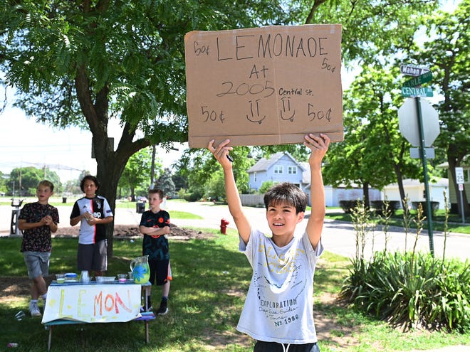 Ben Stone,10,  of Ferndale, waves at motorists to come and buy some lemonade at his stand in Geary Park, Ferndale. He and his friends are selling lemonade for $50 cent a cup.