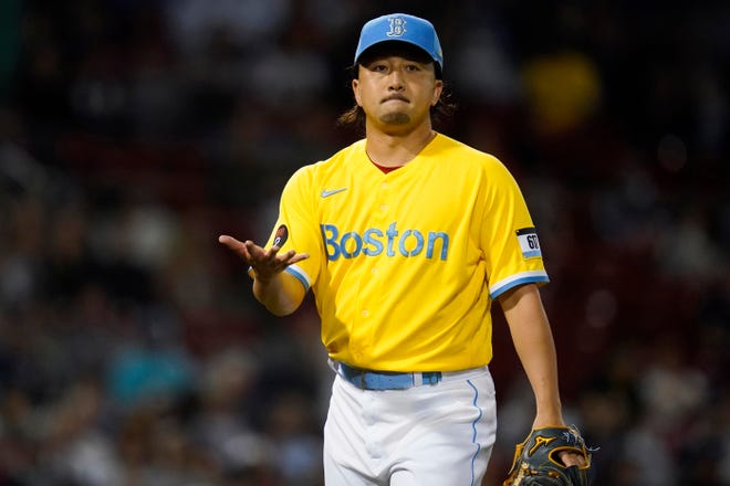 Boston Red Sox relief pitcher Hirokazu Sawamura gestures towards the first base umpire after completing the eighth inning.
