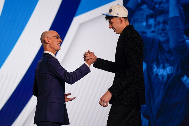 Chet Holmgren, right, is congratulated by NBA Commissioner Adam Silver after being selected second overall in the NBA basketball draft by the Oklahoma Thunder, Thursday, June 23, 2022, in New York.