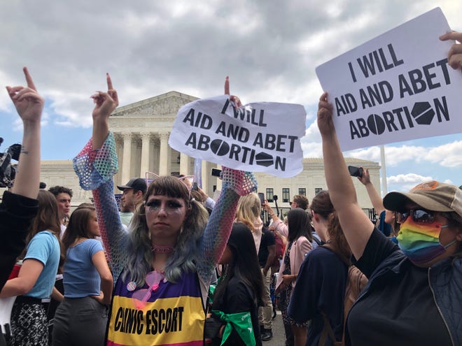 Protesters gather outside the U.S. Supreme Court building Friday, June 24, 2022, after the 6-3 opinion is released, overturning federal protections on access to abortion.