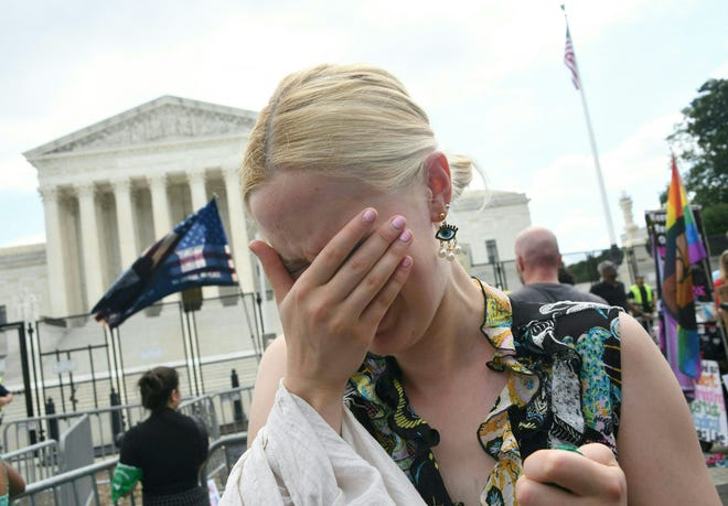 A pro-choice supporter cries outside the US Supreme Court in Washington, DC, on June 24, 2022. The US Supreme Court on Friday ended the right to abortion in a seismic ruling that shreds half a century of constitutional protections on one of the most divisive and bitterly fought issues in American political life. The conservative-dominated court overturned the landmark 1973 "Roe v Wade" decision that enshrined a woman's right to an abortion and said individual states can permit or restrict the procedure themselves.