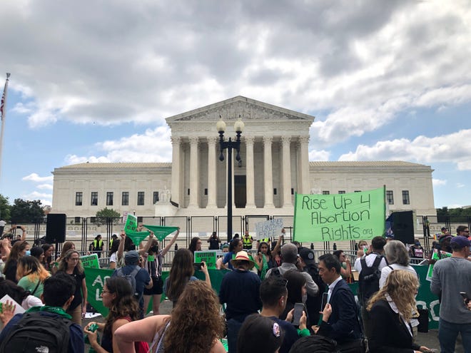 Protesters gather outside the U.S. Supreme Court building Friday, June 24, 2022, after the 6-3 opinion is released, overturning federal protections on access to abortion.