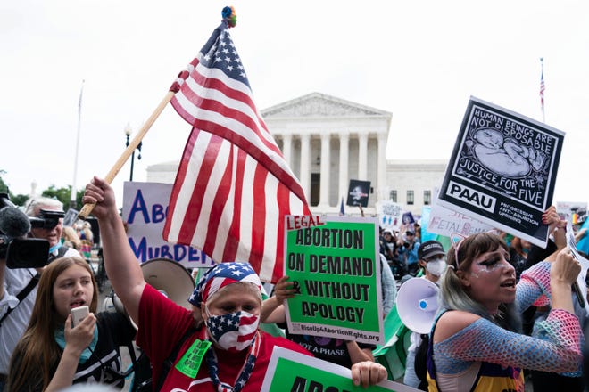anti-abortion and abortion-rights protesters gather outside the Supreme Court in Washington, Friday, June 24, 2022. The Supreme Court has ended constitutional protections for abortion that had been in place nearly 50 years, a decision by its conservative majority to overturn the court's landmark abortion cases.