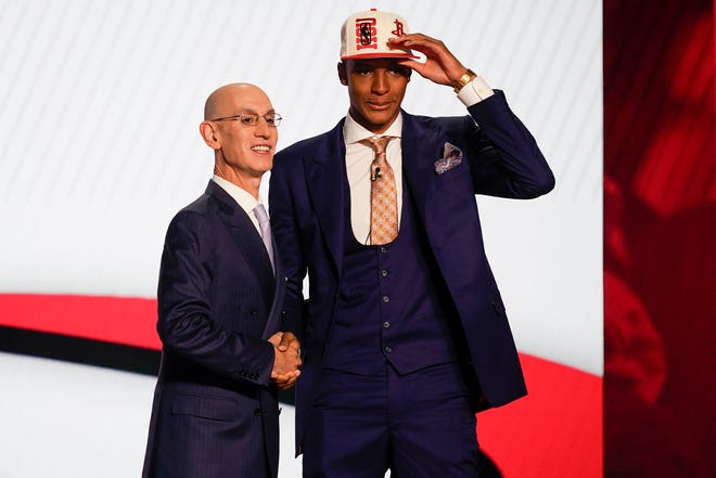 Jabari Smith Jr., right, is congratulated by NBA Commissioner Adam Silver after being selected third overall in the NBA basketball draft by the Houston Rockets, Thursday, June 23, 2022, in New York.