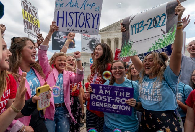 Anti-abortion protesters celebrate following Supreme Court's decision to overturn Roe v. Wade, federally protected right to abortion, outside the Supreme Court in Washington, Friday, June 24, 2022.