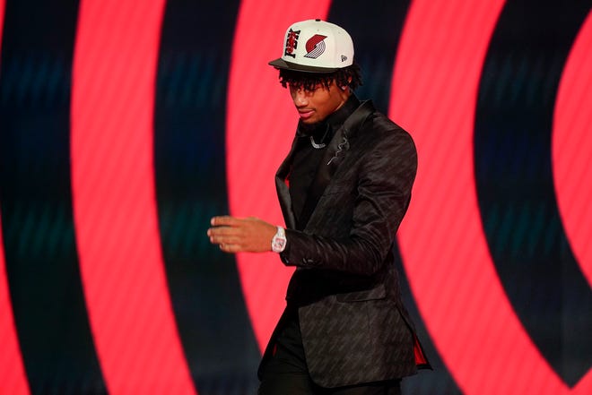 Shaedon Sharpe walks across the stage after being selected seventh overall by the Portland Trailblazers in the NBA basketball draft, Thursday, June 23, 2022, in New York.