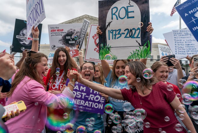 Anti-abortion protesters celebrate following Supreme Court's decision to overturn Roe v. Wade, federally protected right to abortion, outside the Supreme Court in Washington, Friday, June 24, 2022. The Supreme Court has ended constitutional protections for abortion that had been in place nearly 50 years, a decision by its conservative majority to overturn the court's landmark abortion cases.