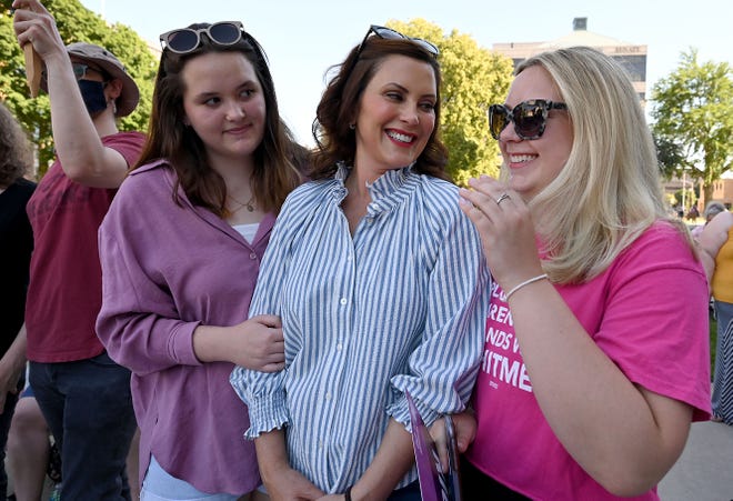 Gov Whitmer and her daughters chat as a crowd of 300-400 people gathered at the steps of the Capitol in Lansing on Friday June 24, 2022, to protest the US Supreme Court's decision to shelve Roe v Wade, and return authority to the States, June 18, 2022.