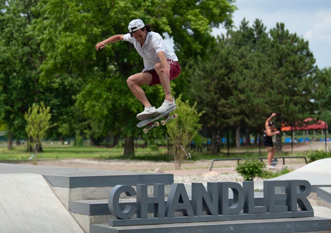 Skater Jordan Zuppke of Royal Oak flies over the 'Chandler' sign during the grand opening of the new Chandler Park Skatepark in Detroit on Sunday, June 26, 2022.