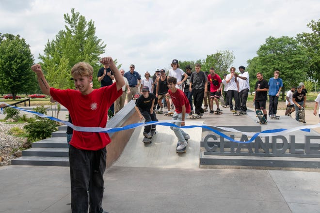 Skater Tyler Beeney, 18, of Westland skates through the ribbon along with other skaters to officially open the new Chandler Park Skatepark in Detroit on Sunday, June 26, 2022.