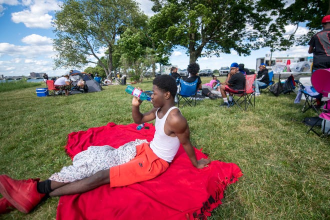 Tyler Thomas of Detroit hangs out before the start of the annual fireworks show, on Belle Isle, in Detroit, June 27, 2022.