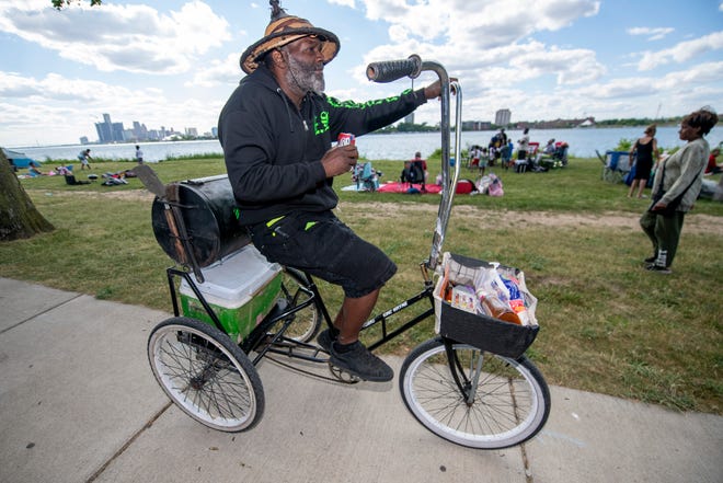 King Wayne of Detroit rides his tricycle equipped with a barbecue before the start of the annual fireworks show, on Belle Isle, in Detroit, June 27, 2022.