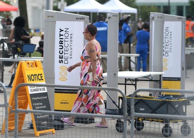 Patrons arrive at a security checkpoint before going into Hart Plaza for the 2022 Ford Fireworks display in Detroit.