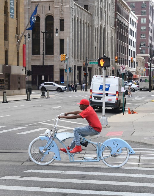 A bicyclists make his way down Woodward Avenue on a beautiful custom ride before the 2022 Ford Fireworks.