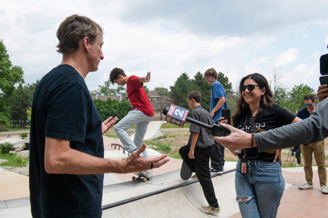 Detroit News reporter Sarah Rahal interviews legendary skateboarder Tony Hawk during the grand opening of the new Chandler Park Skatepark in Detroit.