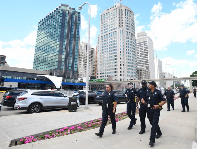 Detroit Police officers make their way to Hunting Place for roll call before the 2022 Ford Fireworks display.
