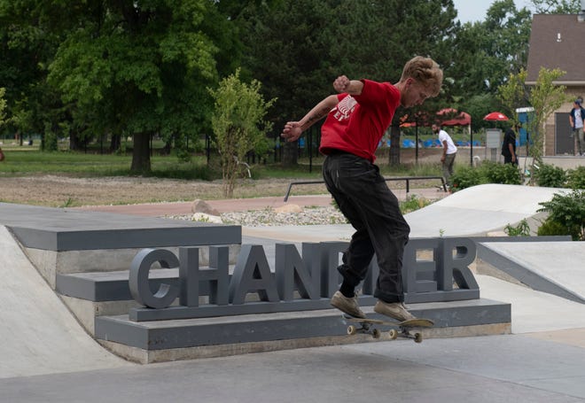 Skater Tyler Beeney, 18, of Westland jumps the ‘Chandler’ sign at the new Chandler Park Skatepark in Detroit.