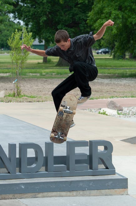 Skater Carsen Beeney, 15, of Westland jumps the ‘Chandler’ sign at the new Chandler Park Skatepark in Detroit.