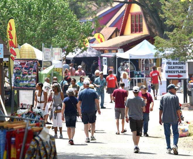 Patrons walk among vendors at the Fifth annual Michigan Rib Fest at Canterbury Village in Orion Twp., Saturday afternoon, July 2, 2022.