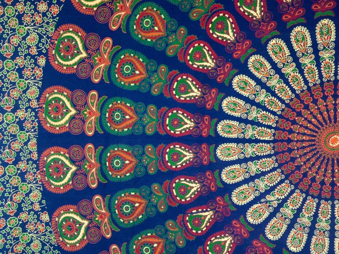 Mandala tapestries can inspire an entire aesthetic for a small space with their colorful pattern and palette.
