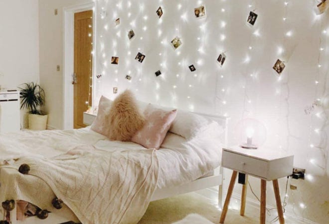 Curtain lights and cozy pillows and bedding can make a temporary dwelling like a college dorm room feel more like home sweet home.