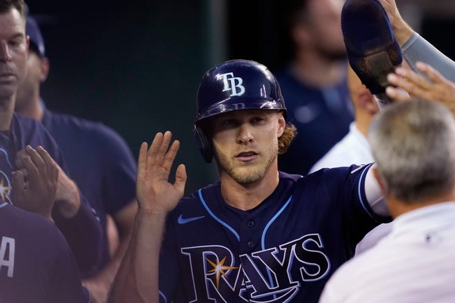 Rays' Taylor Walls is greeted in the dugout after scoring on a double in the fifth inning.