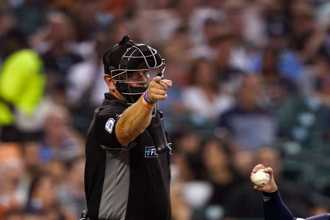 Home plate umpire Scott Barry signals during the fifth inning.