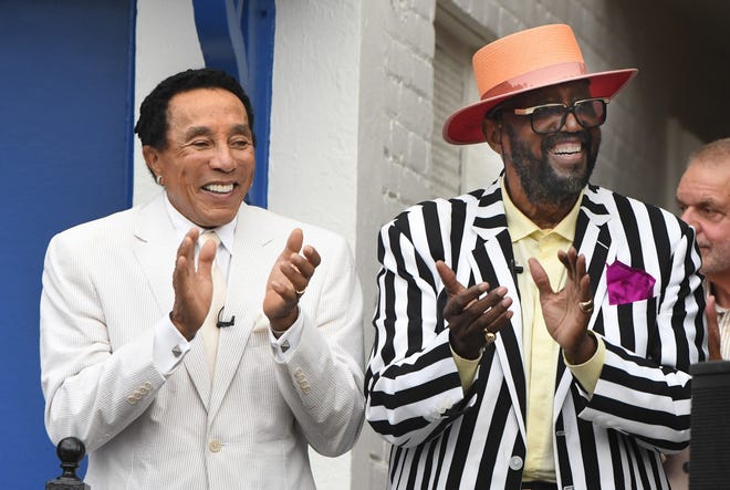 Motown greats Smokey Robinson and original Temptation Otis Williams applaud during the Motown Museum celebration for the completion of two of three phases of an ambitious expansion plan, including a new square in front of the museum, in Detroit, Michigan, on August 8, 2022.