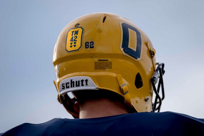 Junior Christian Fresard (62) wears a sticker recognizing Tate Myre before the high school football game between the Oxford Wildcats and Birmingham Groves Falcons at Oxford High School in Oxford, Mich. on Sept. 2, 2022.