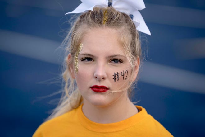 Junior cheerleader Emma Kawala, 16, poses for a portrait before the high school football game between the Oxford Wildcats and Birmingham Groves Falcons at Oxford High School in Oxford, Mich. on Sept. 2, 2022. “I’m feeling nervous,” Kawala said. “But I’m excited to show how strong of a community we are.”