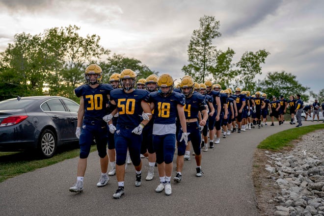 Oxford players make their way to the field before the high school football game between the Oxford Wildcats and Birmingham Groves Falcons at Oxford High School in Oxford, Mich. on Sept. 2, 2022.