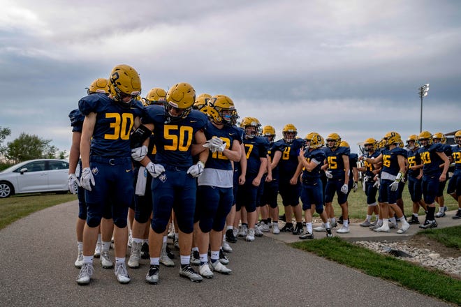 Oxford players make their way to the field before the high school football game between the Oxford Wildcats and Birmingham Groves Falcons at Oxford High School in Oxford, Mich. on Sept. 2, 2022.