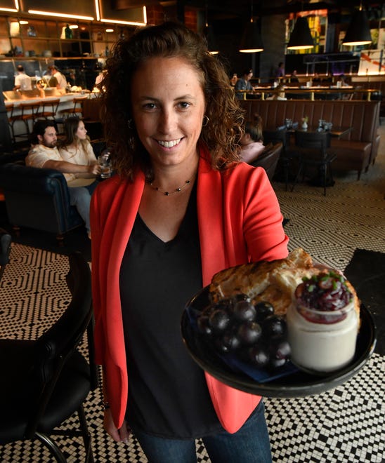 Olin restaurant owner Holly McClain, with a wild mushroom pate, in the dining area.