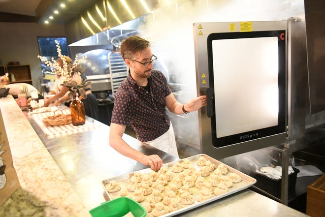 Supergeil executive chef Brendan McCall puts dumplings into a warmer at Dish and Design Cozy Comfort event at  Great Lakes Culinary Center in Southfield, Mich. on Sept. 20, 2022.